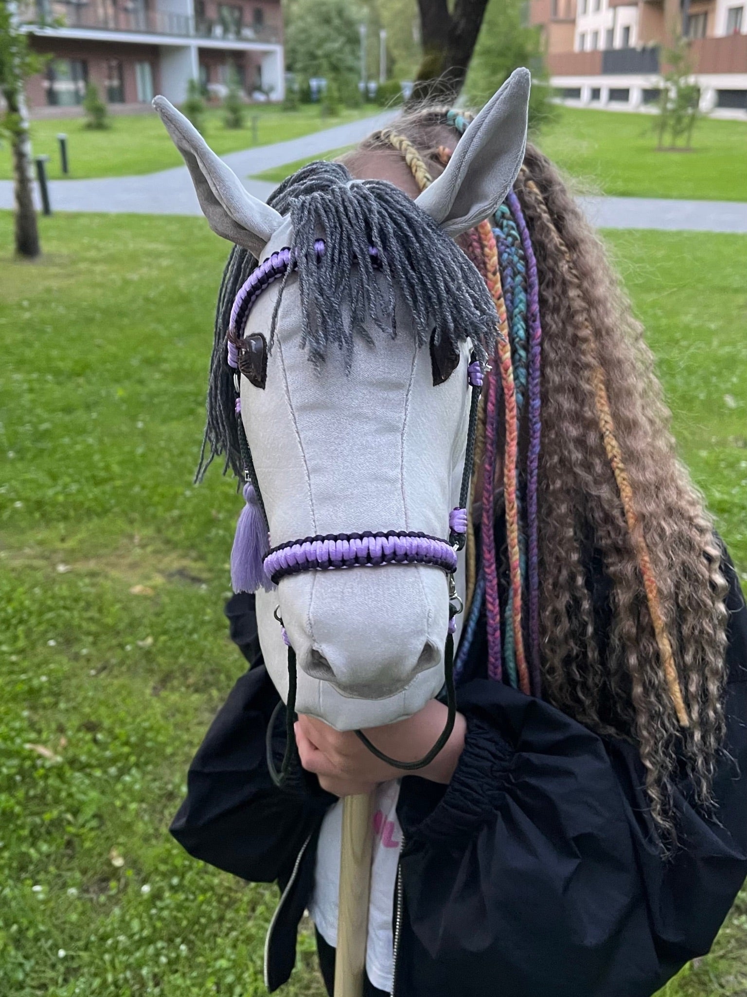 Child playing with handmade hobby horse – light grey stick horse with dark mane, reins, and custom name tag. Perfect toy for imaginative play, hobby horsing, or as a special gift for horse-loving kids.