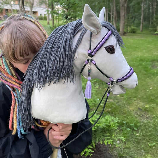 Beautifully crafted grey hobby horse with custom name tag and braided bridle – the perfect personalized gift for horse lovers, birthdays, or special occasions.