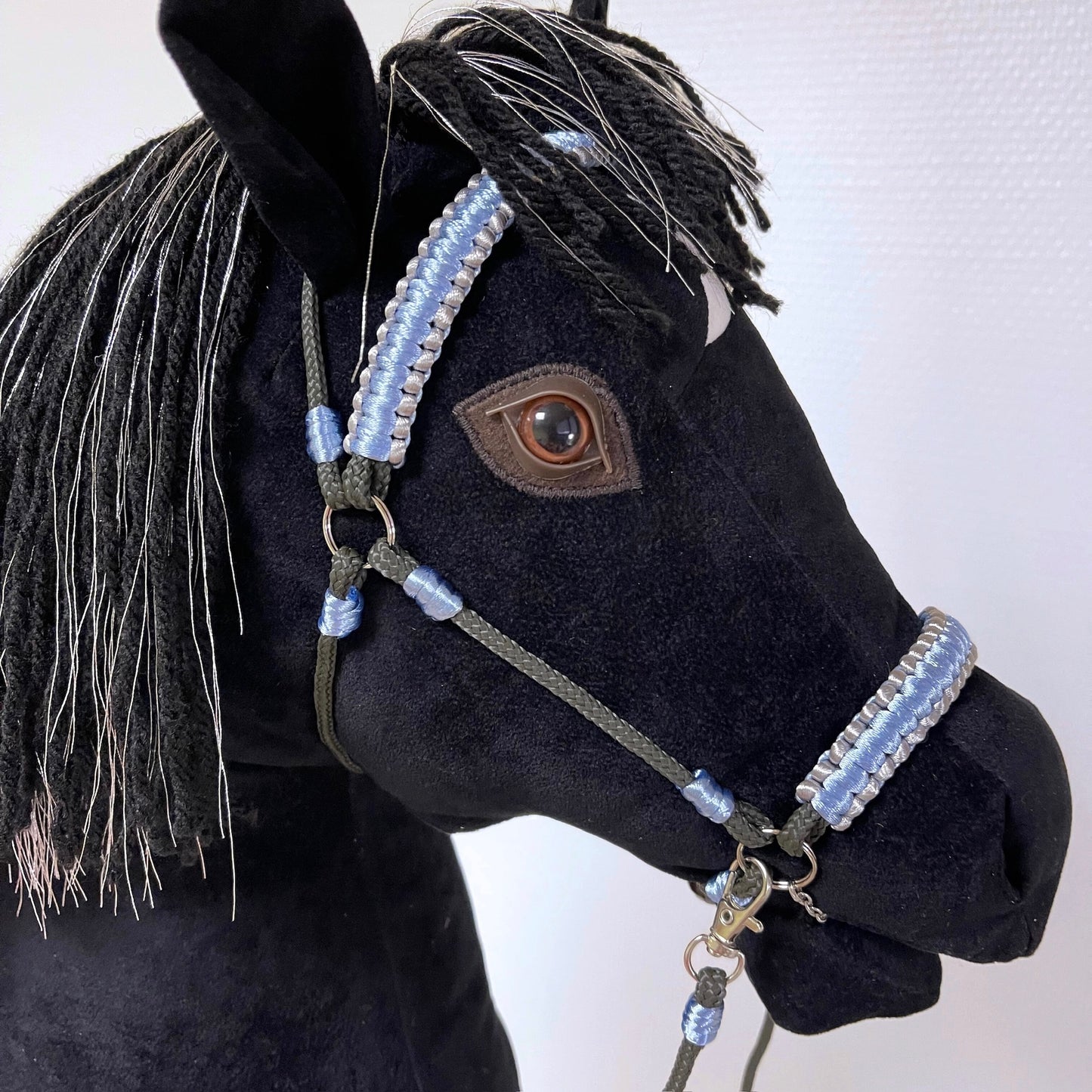 Black hobby horse Silvermoon with silver-thread mane, white crescent marking, and blue-silver bridle – handmade stick horse.