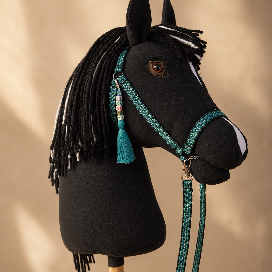 Black hobby horse Eclipse with turquoise bridle, reins, and personalized tassel name tag – handmade stick horse