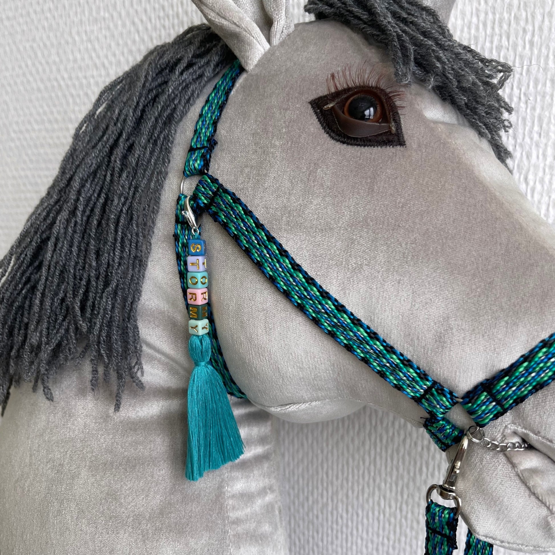 Close-up handmade hobby horse face, velour fabric and detailed stitching