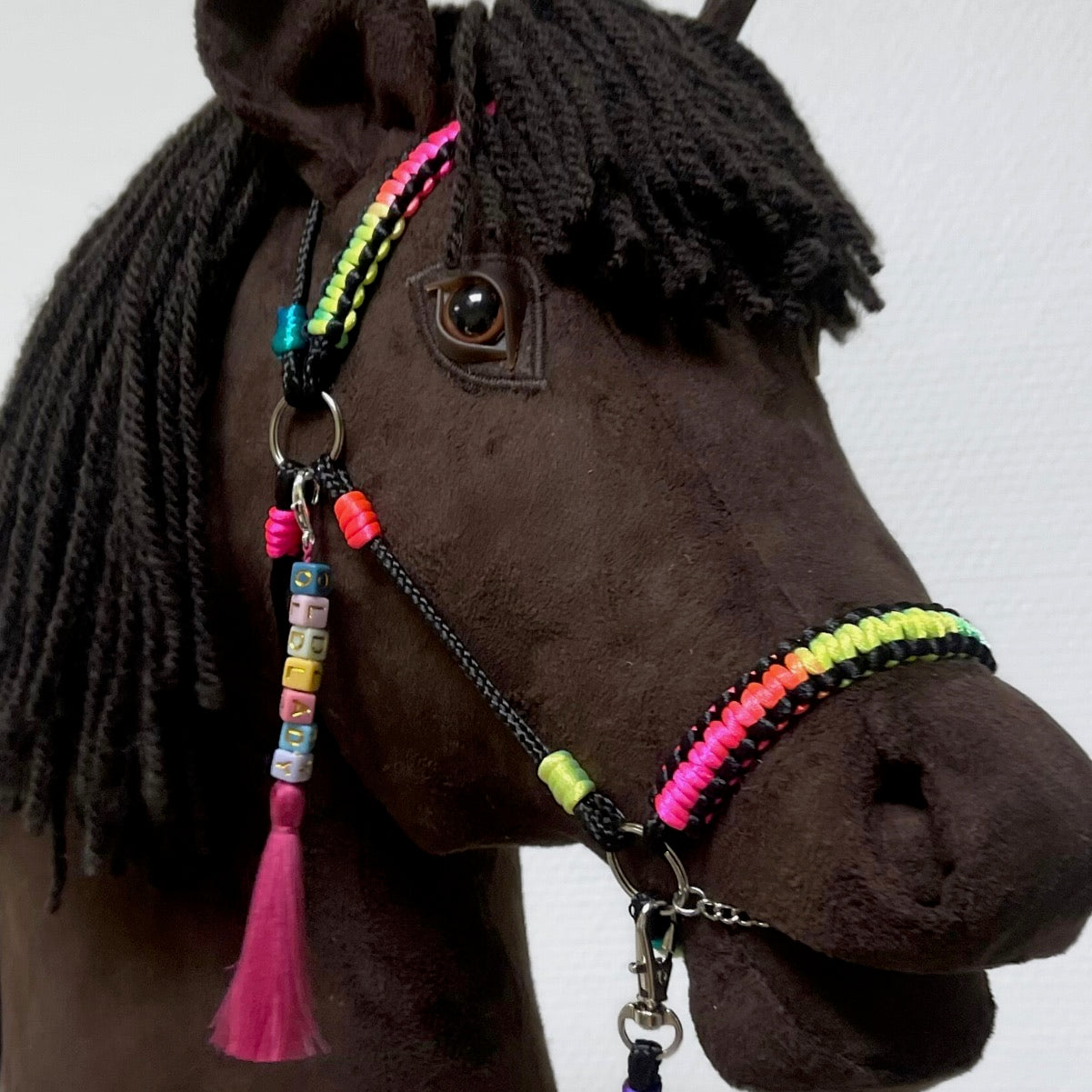 Close-up of hobby horse bridle and personalized name tag with tassel – handmade accessories for stick horse