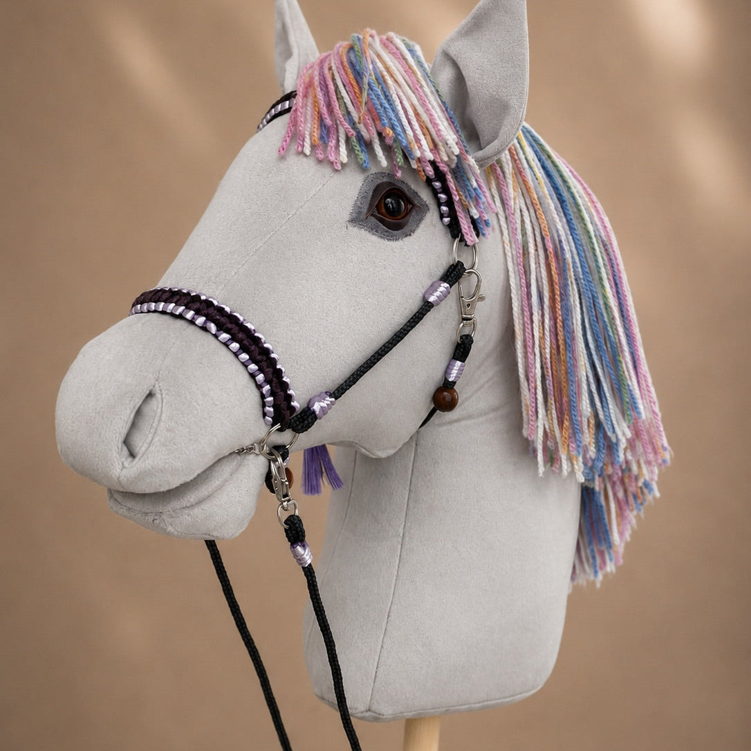 Close-up of handmade hobby horse with realistic eye, pastel rainbow mane, and personalized name tag