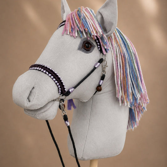 Close-up of handmade hobby horse with realistic eye, pastel rainbow mane, and personalized name tag