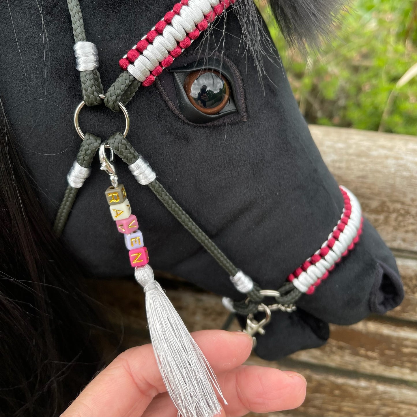 Close-up of handmade hobby horse with realistic eye, black hair mane, and custom bridle