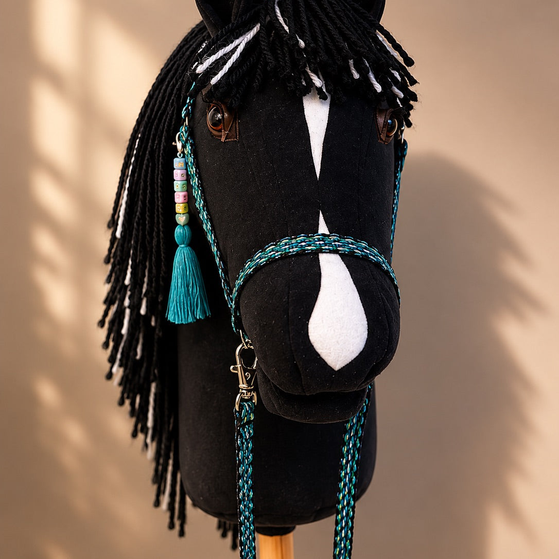 Close-up of black hobby horse with realistic eye, white blaze, and turquoise handmade bridle