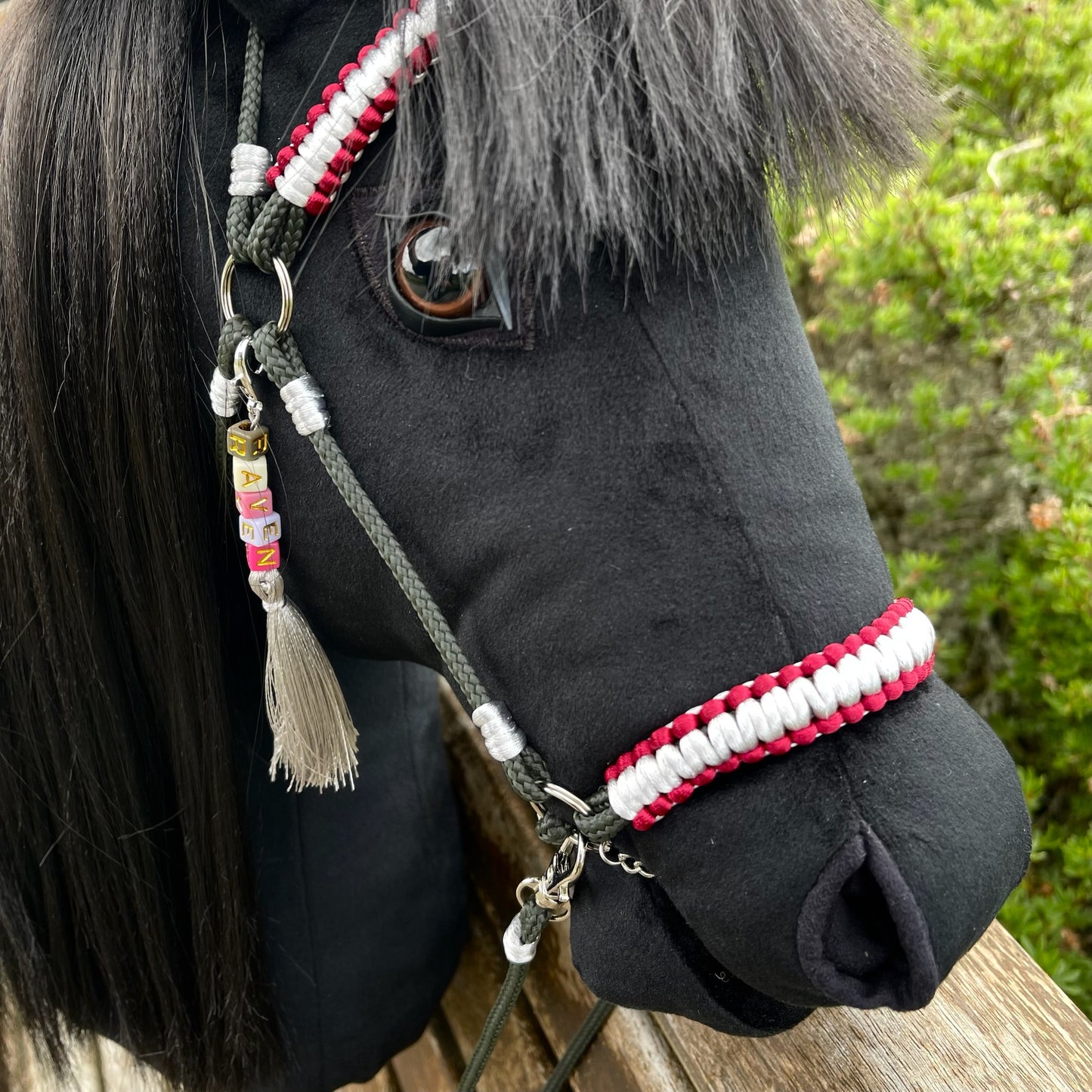 Front view of realistic black hobby horse with premium synthetic hair mane and handcrafted tack